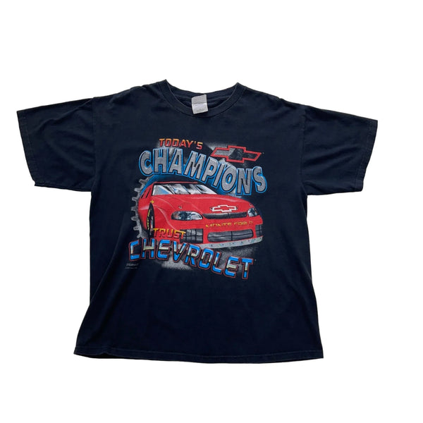 Vintage Vintage Black T-shirt With A Front Graphic Of A Red Chevrolet Monte Carlo Race Car And Text 'Today's Champions Trust Chevrolet'. T-Shirt Black Size Extra Large