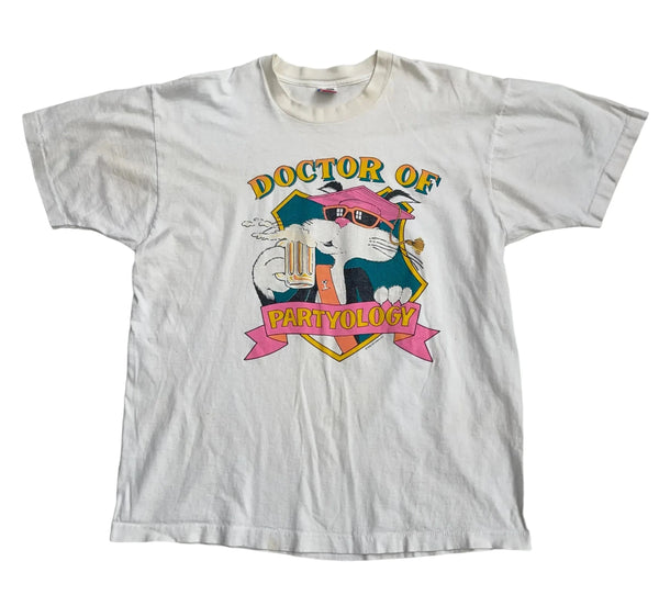 Vintage Fruit Of The Loom Vintage White T-shirt With A Colorful Graphic Of A Cat Wearing Sunglasses, Holding A Beer. Text Reads 'Doctor Of Partyology'. Soft, Worn-in Fabric, Short Sleeves. T-shirt White Size Extra Large