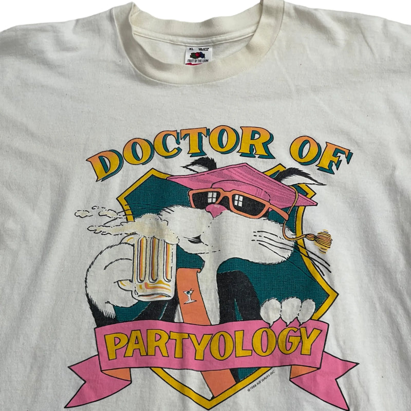 Vintage Fruit Of The Loom Vintage White T-shirt With A Colorful Graphic Of A Cat Wearing Sunglasses, Holding A Beer. Text Reads 'Doctor Of Partyology'. Soft, Worn-in Fabric, Short Sleeves. T-shirt White Size Extra Large