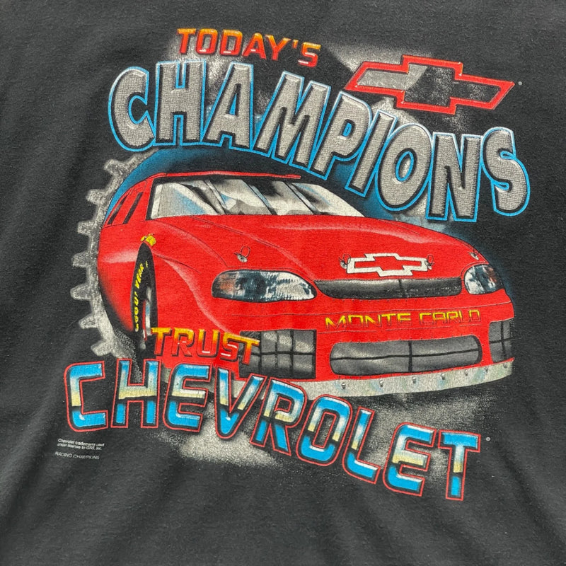 Vintage Vintage Black T-shirt With A Front Graphic Of A Red Chevrolet Monte Carlo Race Car And Text 'Today's Champions Trust Chevrolet'. T-Shirt Black Size Extra Large