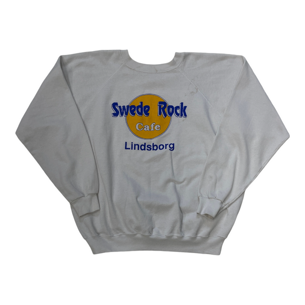 Vintage Hanes White Sweatshirt Featuring 'Swede Rock Cafe Lindsborg' Print In Blue And Yellow. Ribbed Cuffs And Neckline. Sweater White Size Extra Large